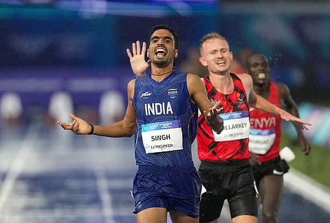 Gulveer Singh, of India, crosses the finish line to win the silver medal in the men's 10,000 meters final at the Commonwealth Games in Glasgow, Scotland, Tuesday, July 28, 2026. 