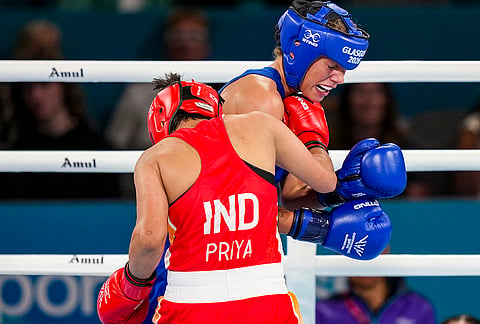 India's Priya Ghanghas, red, and Scotland's Niamh Mitchell in action during the Women's 60kg quarter-final boxing match at the Commonwealth Games 2026, in Glasgow, Scotland, Tuesday, July 28, 2026. 
