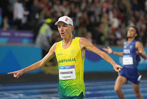 Ky Robinson, of Australia, crosses the finish line ahead of Gulveer Singh, of India, to win the gold medal in the men's 10,000 meters final at the Commonwealth Games in Glasgow, Scotland, Tuesday, July 28, 2026. 