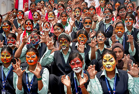 Students of Patna Women's College participate in a face-painting competition on the occasion of International Tiger Day, in Patna, Bihar.