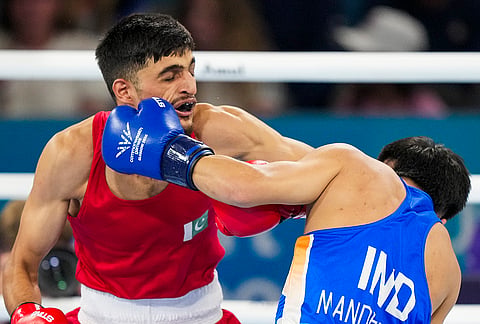 India's Jadumani Singh Mandengbam, blue, competes against Pakistan’s Sumama Rehman during the men's 55kg boxing round of 16 at the 23rd Commonwealth Games, in Glasgow, Scotland, Sunday, July 26, 2026. 