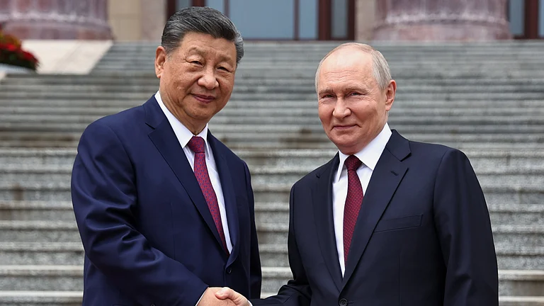 Russian President Vladimir Putin, right, and Chinese President Xi Jinping shake hands during a welcome ceremony at the Great Hall of the People, in Beijing, China, on Wednesday, May 20, 2026. - Alexander Kazakov