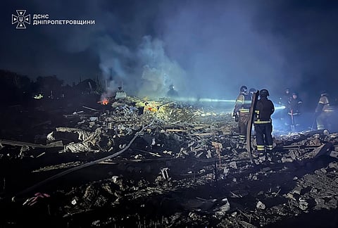 In this photo provided by the Ukrainian Emergency Service, rescuers search through the rubble at a private house following Russian air attack in Dnipropetrovsk region, Ukraine.