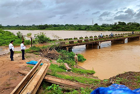 Police personnel inspect the rising water level of the Indravati river at Khadag Ghat following rainfall, at Jagdalpur, in Bastar district.