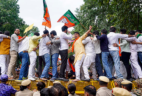 BJP supporters stage a protest at Aam Aadmi Party office demanding the resignation of Punjab Education Minister Harjot Singh Bains over alleged paper leaks in the state, in New Delhi.