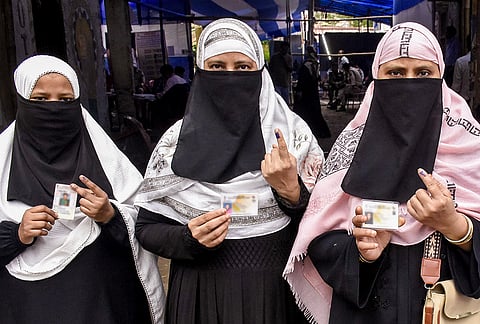 Voters show their inked fingers after casting their vote at a polling station during the Bankipur Assembly by-election, in Patna. 