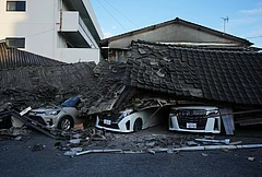 Vehicles are crushed under collapsed buildings in Yatsushiro, southwestern Japan, Wednesday, July 29, 2026, the day after an earthquake hit the area. - | Photo: AP/Hiro Komae