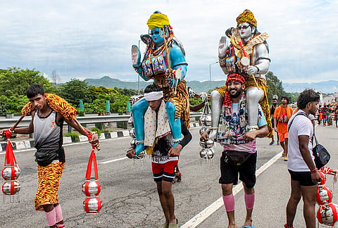 'Kawariyas' carry idols of Lord Shiva and Ganga water during the holy month of 'Sawan', in Haridwar, Uttarakhand.