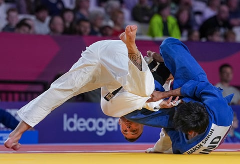 India's Harsh Singh, in blue, competes against Australia's Antun Neto Pedro Carlos during a men's 60kg semifinal judo match at the 23rd Commonwealth Games, in Glasgow, Scotland, Friday, July 31, 2026. Singh stormed into the final and will face Australia's Joshua Katz.
