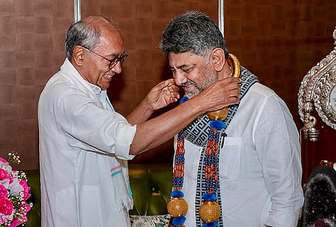 Karnataka Chief Minister DK Shivakumar being felicitated by senior Congress leader Digvijaya Singh during a meeting, at CM’s residence, in Bengaluru. 
