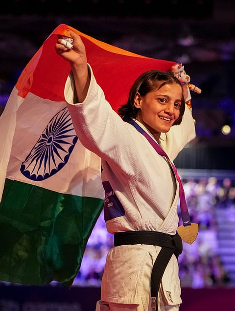 India's Asmita Dey celebrates with the national flag after winning the gold medal in the Women's 48kg judo event at the Commonwealth Games 2026, in Glasgow, Scotland, Friday, July 31, 2026. 
