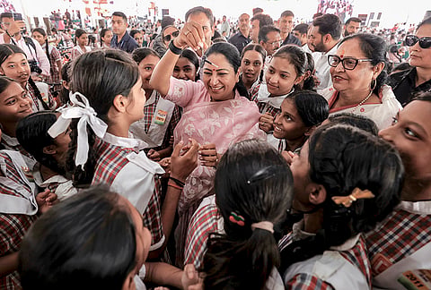 Delhi Chief Minister Rekha Gupta with students during the distribution of bicycles to more than 3,000 Class IX girl students under the ‘Vidya Vahini Yojana’ scheme, in New Delhi. 