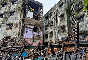 | Photo: PTI : Damaged remains at the site after a portion of the Kohinoor Building in Balaji Nagar area of the powerloom town collapsed on late Thursday, in Bhiwandi, Maharashtra.