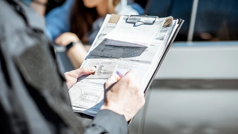 A police officer writing a traffic ticket on a clipboard