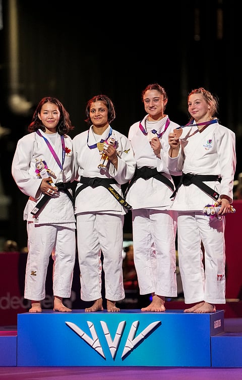 Gold medallist India's Asmita Dey, second from left, silver medallist Canada's Heidi Quach, left, and bronze medallists Scotland's Summer Shaw, second from right, and England's Sian Bobrowska pose during the medal ceremony for the Women's 48kg judo event at the Commonwealth Games 2026, in Glasgow, Scotland, Friday, July 31, 2026.