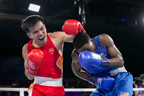 India's Jadumani Singh Mandengbam, red, and Namibia's Philip Pumulo Mutakela Haoseb in action during the Men's 55kg boxing semifinal at the Commonwealth Games 2026, in Glasgow, Scotland, Friday, July 31, 2026.