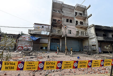 A Delhi court on Friday, July 31, 2026, sentenced former AAP councillor Tahir Hussain and four others to life imprisonment for the murder of IB officer Ankit Sharma during the 2020 Delhi riots. Police personnel stand guard as Tahir's residence is cordoned off amid an investigation in the case, in New Delhi, in this file photo dated Friday, Feb. 28, 2020. 