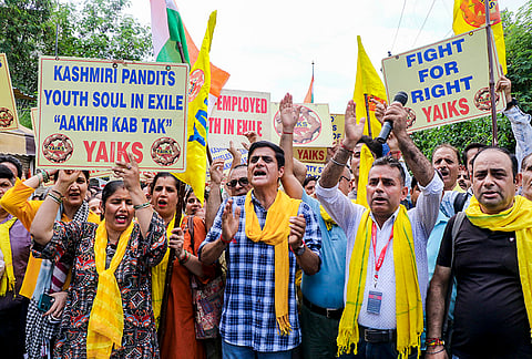 Members of the Youth All India Kashmiri Samaj (YAIKS) raise slogans during a protest, in Jammu.