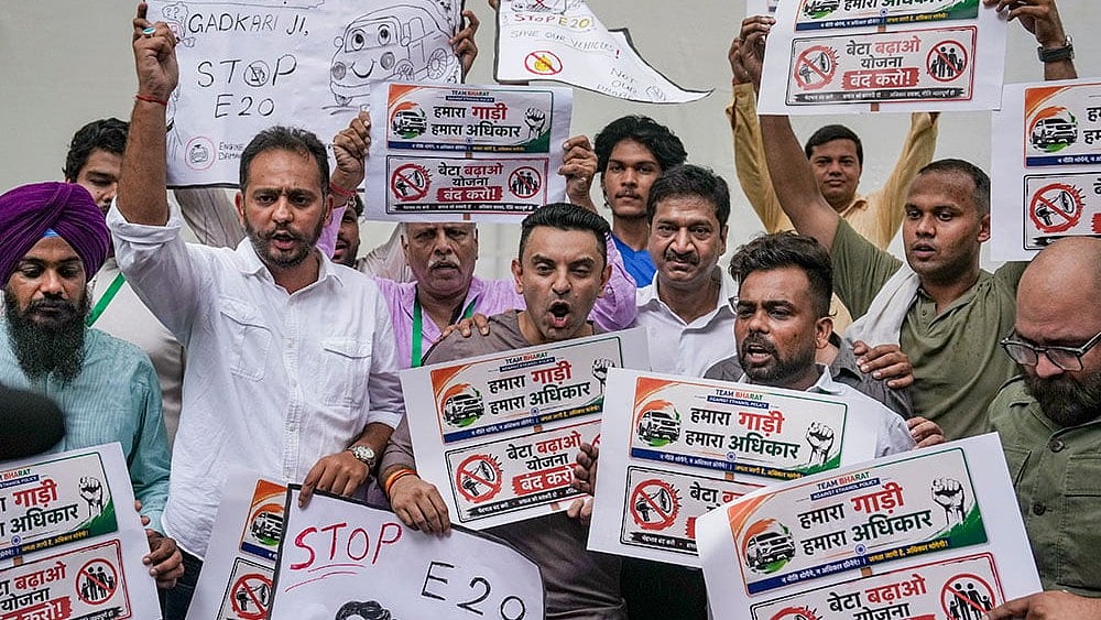 Tehseen Poonawalla and others hold posters during a protest over the mandatory implementation of the 20% ethanol blending (E20) policy in petrol, at Jantar Mantar in New Delhi. - Photo: PTI/Karma Bhutia