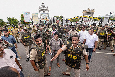 Police personnel deployed during a protest over the release of Cauvery river water to Tamil Nadu, in Mandya district, Karnataka, Friday, July 31, 2026. 
