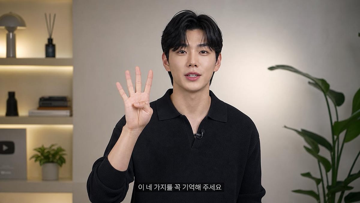 A man holding up four fingers while speaking