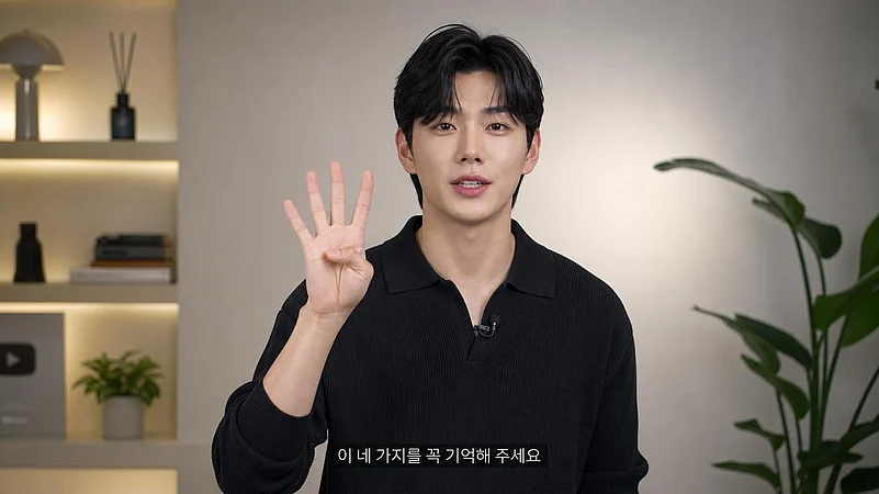 A man holding up four fingers while speaking