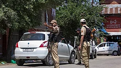 Security personnel keep a vigil during an inspection of vehicles to maintain public safety - | Photo: PTI