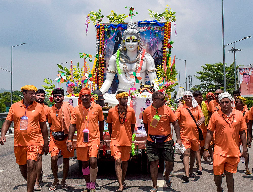 Kanwariyas' take out a 'Kanwar Yatra' procession with an idol of Lord Shiva during the holy month of 'Sawan' - | Photo: PTI