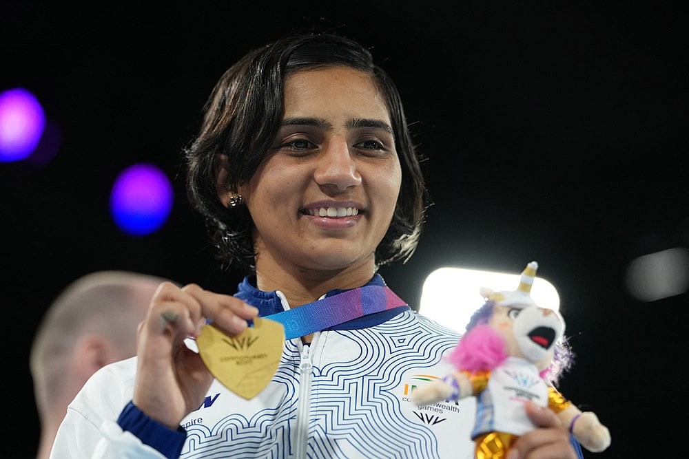 Gold medalist India's Preeti Pawar celebrates after winning the women's 54kg boxing final at the Commonwealth Games in Glasgow, Scotland. - | Photo: AP/Eranga Jayawardena