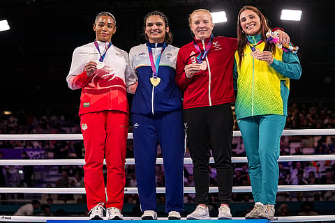 Gold medallist India's Arundhati Choudhary, second left, silver medallist England's Chantelle Reid, left, and bronze medallists Wales' Rosie Eccles, second left, and Australia's Lekeisha Pergoliti pose for photographs during the presentation ceremony after the women's 70kg final boxing event at the 23rd Commonwealth Games (CWG), in Glasgow, Scotland.