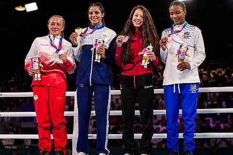 Gold medallist India's Sakshi Chaudhary, second left, silver medallist England's Ruby White, left, and bronze medallists Canada's Amber Jane Wall, second right, and Namibia's Mischa Monique Araes pose for photographs during the presentation ceremony after the women's 51kg final boxing event at the 23rd Commonwealth Games (CWG), in Glasgow, Scotland.
