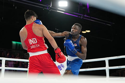England's Dimeji Shittu, right, competes with India's Ankush Panghal in the men's 80kg boxing final at the Commonwealth Games in Glasgow, Scotland.