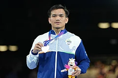 Silver medalist India's Jadumani Singh Mandengbam celebrates after winning the men's 55kg boxing final at the Commonwealth Games in Glasgow, Scotland. - | Photo: AP/Eranga Jayawardena