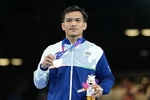 | Photo: AP/Eranga Jayawardena : Silver medalist India's Jadumani Singh Mandengbam celebrates after winning the men's 55kg boxing final at the Commonwealth Games in Glasgow, Scotland.