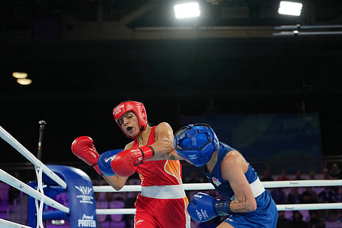 England's Ruby White, left, is punched by India's Sakshi Chaudhary during the women's 51kg boxing final at the Commonwealth Games in Glasgow, Scotland.