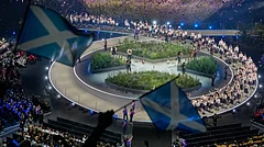 Scottish flags are waved by fans as the Scotland team arrives on stage during the Commonwealth Games opening ceremony in Glasgow, Scotland, Thursday, July 23, 2026 - (AP Photo/Manish Swarup)
