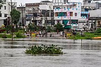 Day In Pics: August 02, 2026 | Photo: PTI : People stand near a cordoned-off area after torrential rains, in Jambuva area, Vadodara.