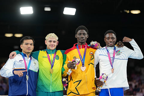 From left, silver medalist India's Jadumani Singh Mandengbam, gold medalist Australia's Jye Dixon , bronze medalists Amadu Mohammed of Ghana and Philip Pumulo Mutakela Haoseb of Namibia, celebrate after winning the men's 55kg boxing final at the Commonwealth Games in Glasgow, Scotland.