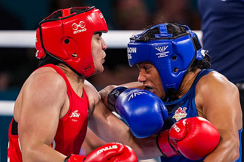 India's Arundhati Choudhary, in red, competes against England's Chantelle Reid in the women's 70kg final boxing bout at the 23rd Commonwealth Games (CWG), in Glasgow, Scotland. Chaudhary bagged the gold medal in the event.