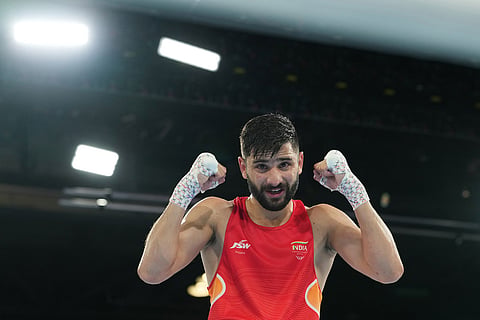 India's Sachin Siwach celebrates after winning the men's 60kg boxing final at the Commonwealth Games in Glasgow, Scotland.