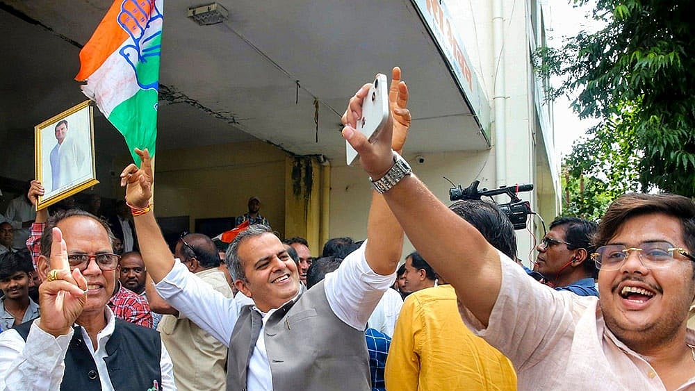 Congress workers celebrate the party's victory in the Datia Assembly by-election at the Pradesh Congress Committee (PCC) headquarters, in Bhopal. Congress candidate Ghanshyam Singh defeated BJP's Ashutosh Tiwari in the bypoll.  - | Photo: PTI