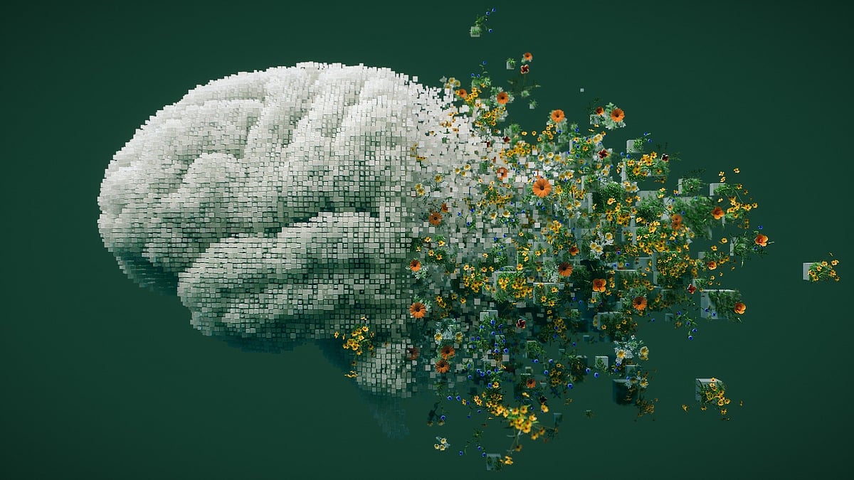 A pixelated human brain bursting into colorful flowers