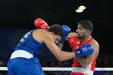 India's Narender Berwal, right, competes with England's Damar Thomas in the men's 90kg boxing final at the Commonwealth Games in Glasgow, Scotland.