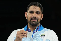 India's Narender Berwal, silver medalist, celebrates on the podium of the men's 90kg boxing final at the Commonwealth Games in Glasgow, Scotland. - | Photo: AP/Eranga Jayawardena