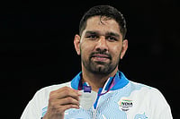 | Photo: AP/Eranga Jayawardena : India's Narender Berwal, silver medalist, celebrates on the podium of the men's 90kg boxing final at the Commonwealth Games in Glasgow, Scotland.