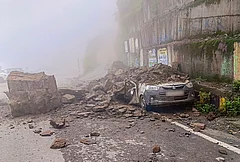 A car lies crushed under boulders after a landslide triggered by heavy monsoon rains at Theog, in Shimla district, Monday, Aug. 3, 2026. - | Photo: PTI
