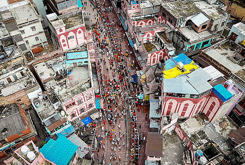 An aerial view of devotees standing in a long queue to offer prayers at the Kashi Vishwanath Temple on the first Monday of 'Shravan' month, in Varanasi.