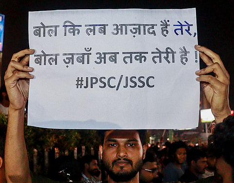 A student holds a poster during a protest over alleged irregularities in the 14th JPSC examination, JSSC-CGL and other recruitment tests, demanding a CBI probe and reforms in the recruitment agencies, in Ranchi, Jharkhand, Sunday, Aug. 2, 2026. 