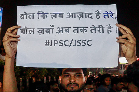 A student holds a poster during a protest over alleged irregularities in the 14th JPSC examination, JSSC-CGL and other recruitment tests, demanding a CBI probe and reforms in the recruitment agencies, in Ranchi, Jharkhand.