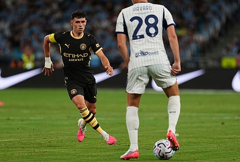 Manchester City's Phil Foden, left competes with Inter Milan's Benjamin Pavard for the ball during a pre-season friendly match for the Hong Kong Football Festival in Hong Kong on Saturday, Aug. 1, 2026. 